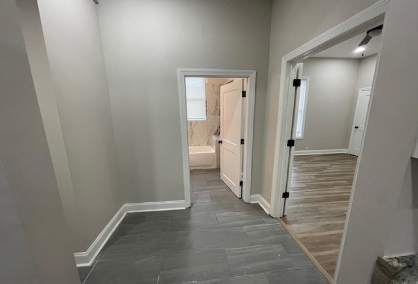 Hall with baseboards and dark wood-type flooring