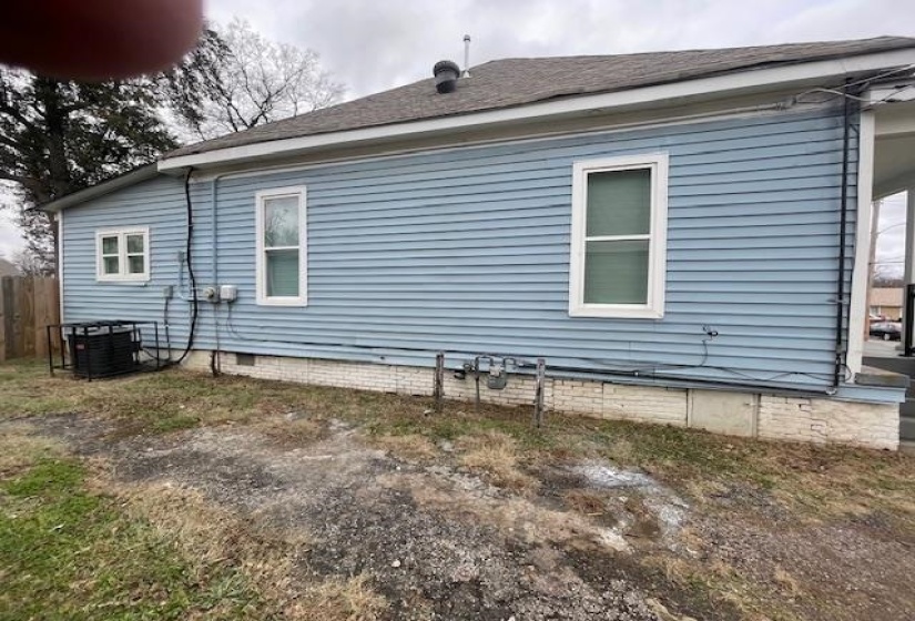 View of home's exterior with roof with shingles and crawl space