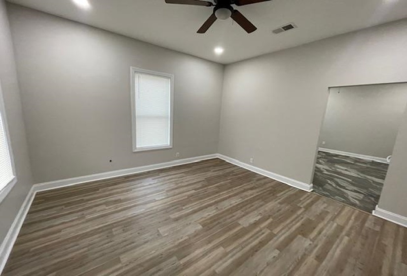 Empty room featuring dark wood finished floors, recessed lighting, and a ceiling fan