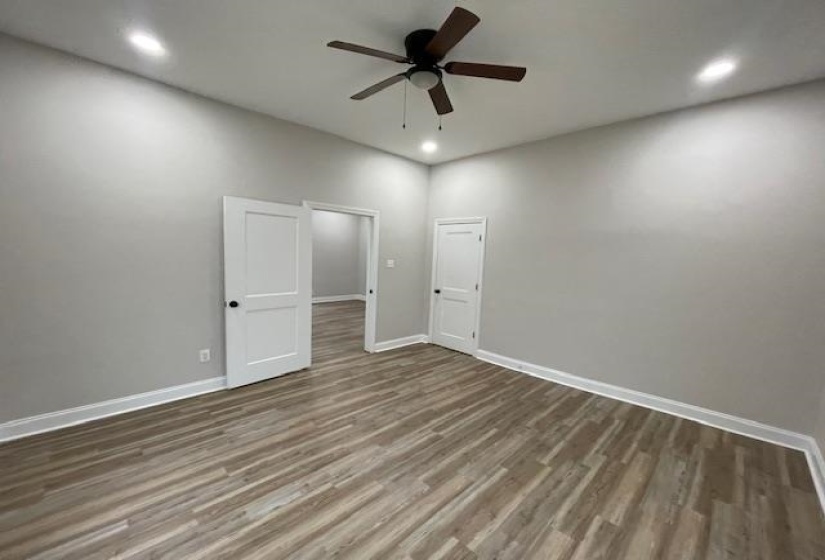 Empty room with wood finished floors, recessed lighting, and ceiling fan
