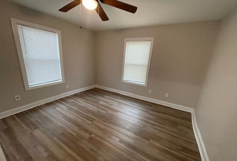 Empty room with light wood finished floors and ceiling fan