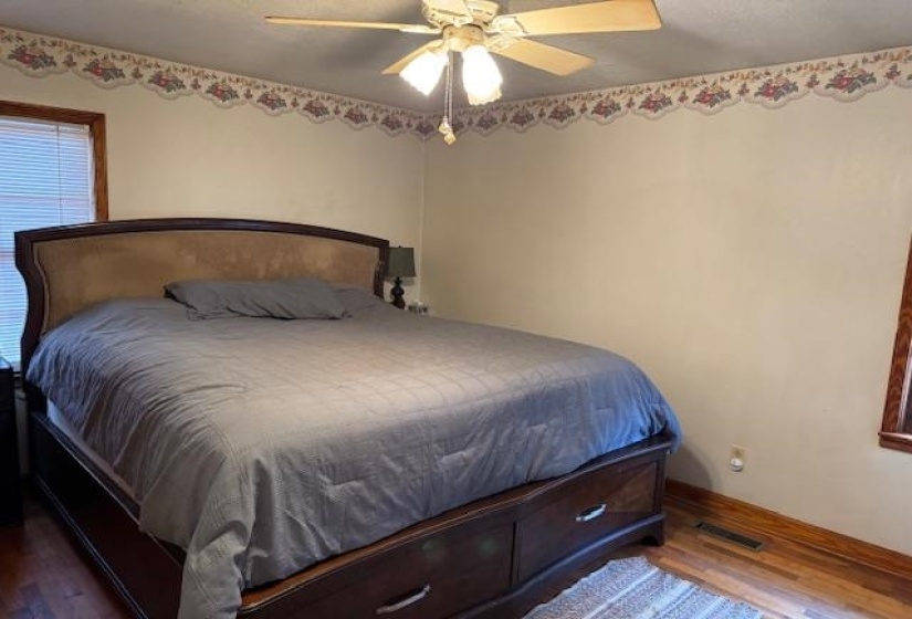 Bedroom featuring dark wood finished floors and ceiling fan