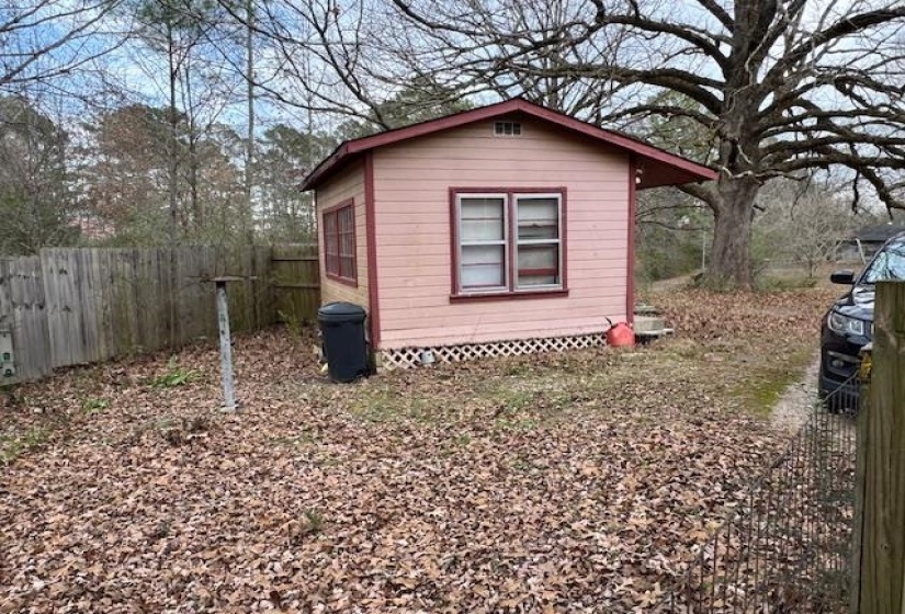 View of side of home featuring an outdoor structure