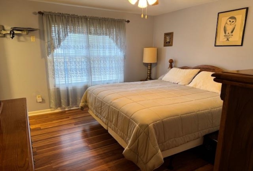 Bedroom featuring wood finished floors and a ceiling fan