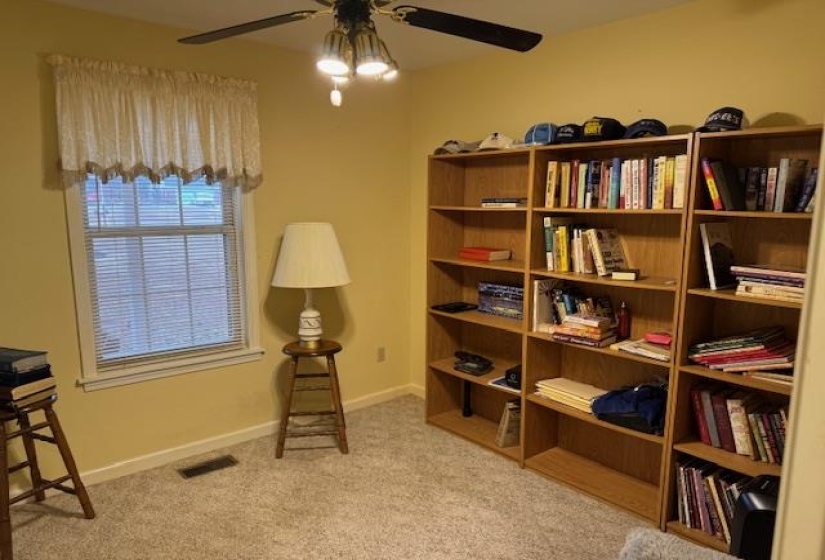 Sitting room featuring ceiling fan and light colored carpet