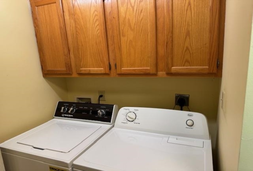 Laundry room with independent washer and dryer and cabinet space