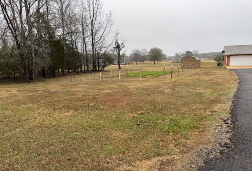 View of yard with an outdoor structure, a view of countryside, and a garage