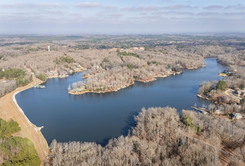 Aerial view of property and surrounding area with a large body of water