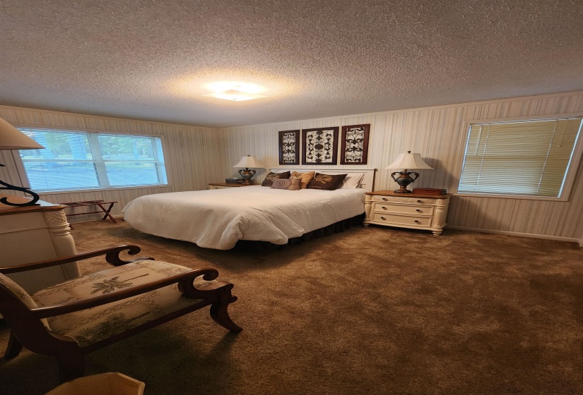 Bedroom with carpet floors and a textured ceiling