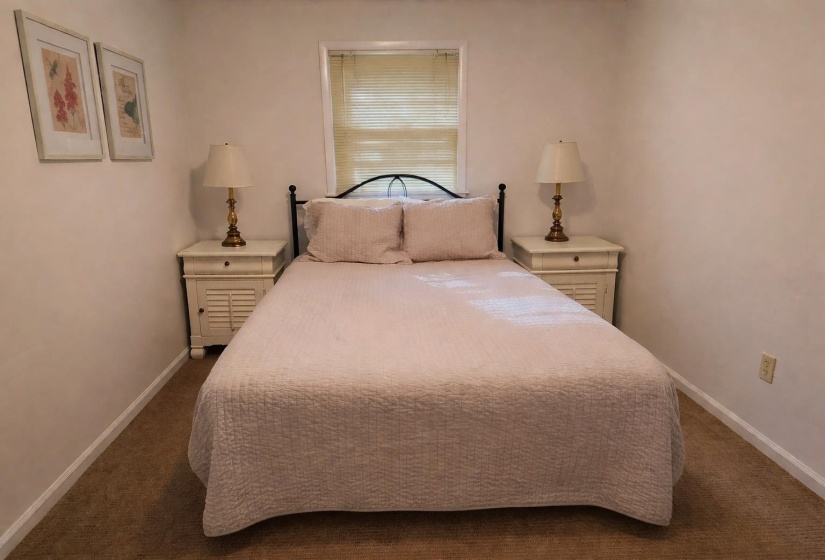Bedroom with baseboards and dark carpet