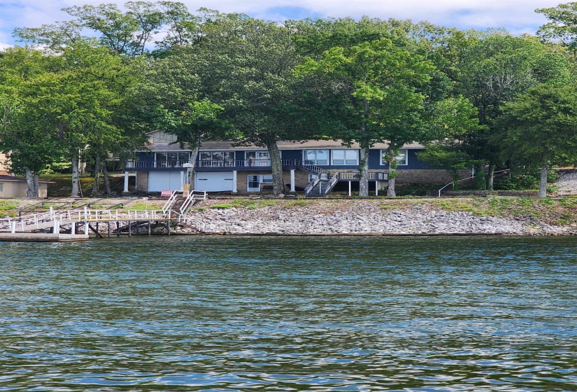 Water view featuring stairway and a dock