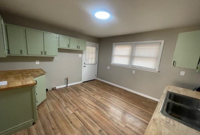 Washroom with baseboards and light wood-style floors