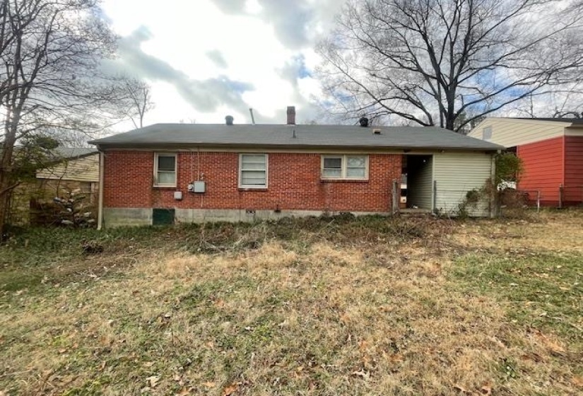 Rear view of property with brick siding and crawl space