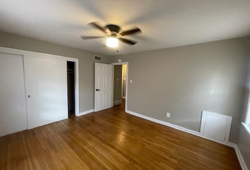 Unfurnished bedroom featuring a closet, wood finished floors, and ceiling fan