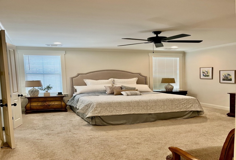 Carpeted bedroom with crown molding, ceiling fan, and recessed lighting