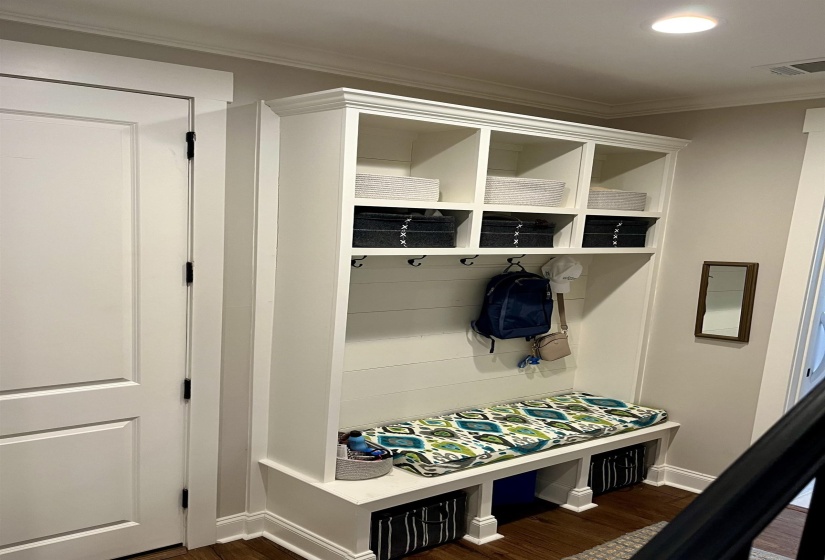 Mudroom featuring dark wood-type flooring, ornamental molding, and recessed lighting