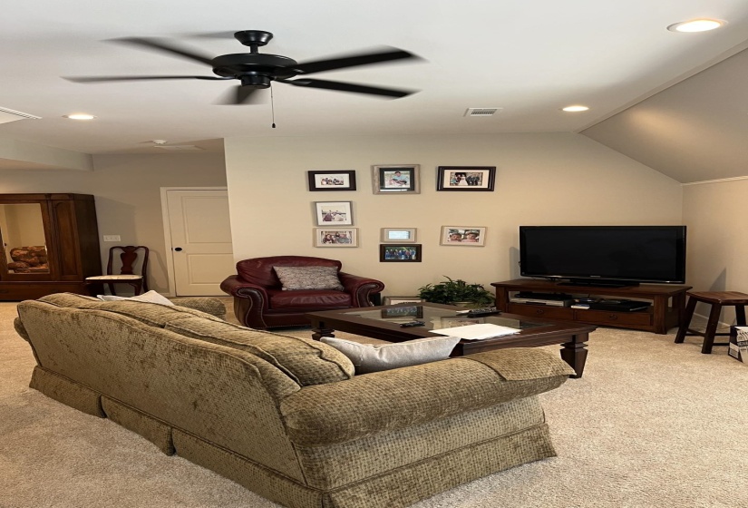 Living room with recessed lighting, carpet, lofted ceiling, and a ceiling fan