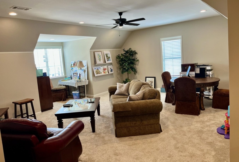 Living room featuring recessed lighting, light colored carpet, vaulted ceiling, and ceiling fan