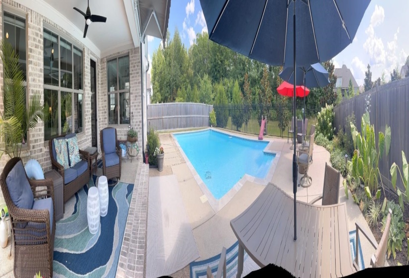 View of swimming pool with a fenced backyard, a patio area, and a ceiling fan