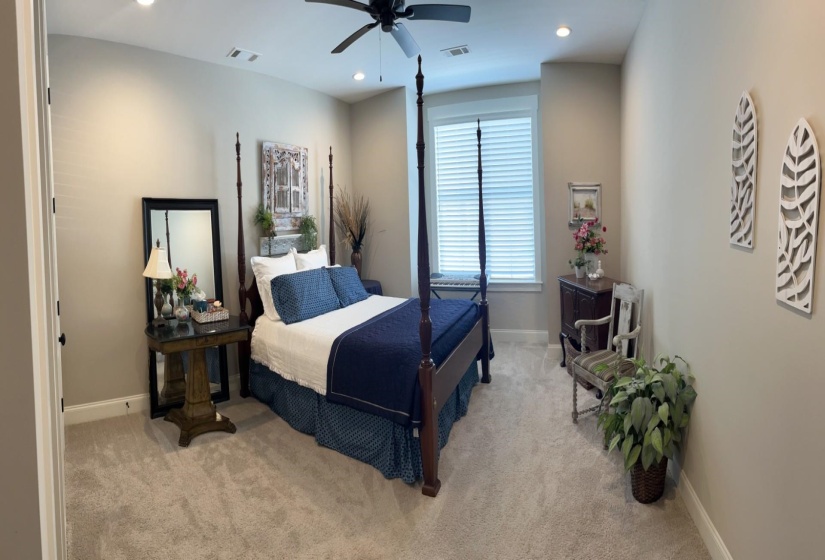 Carpeted bedroom with recessed lighting and ceiling fan