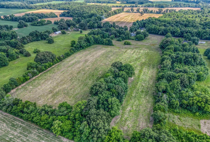 Aerial overview of property's location with rural landscape and farmland