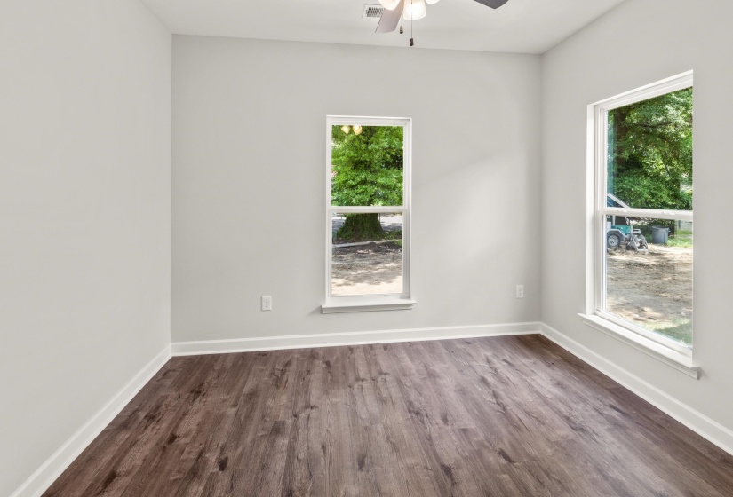 Spare room with dark wood finished floors and ceiling fan