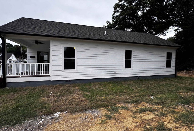 Back of house featuring roof with shingles, a ceiling fan, a yard, and crawl space
