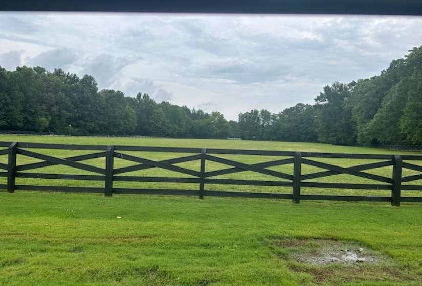 View of gate featuring a lawn and a rural view