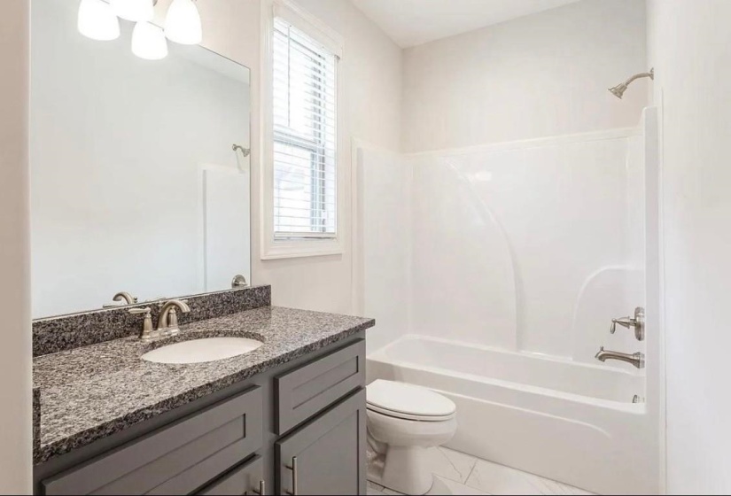 Full bathroom featuring tub / shower combination and vanity