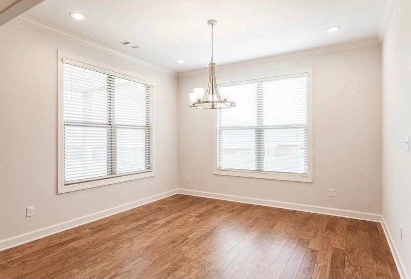Unfurnished room with light wood-style flooring, crown molding, a chandelier, and recessed lighting