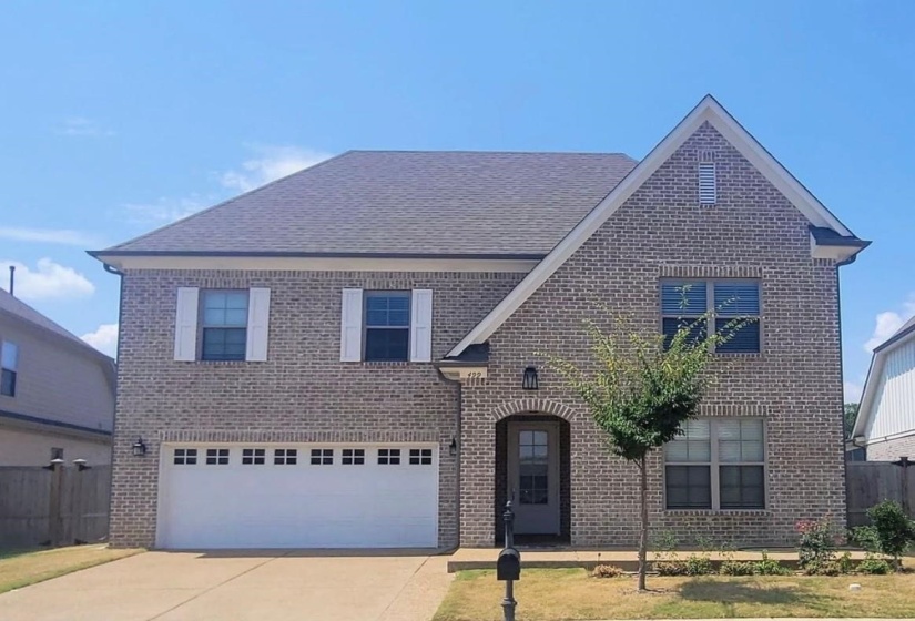 View of front of home with brick siding, concrete driveway, a garage, and a shingled roof