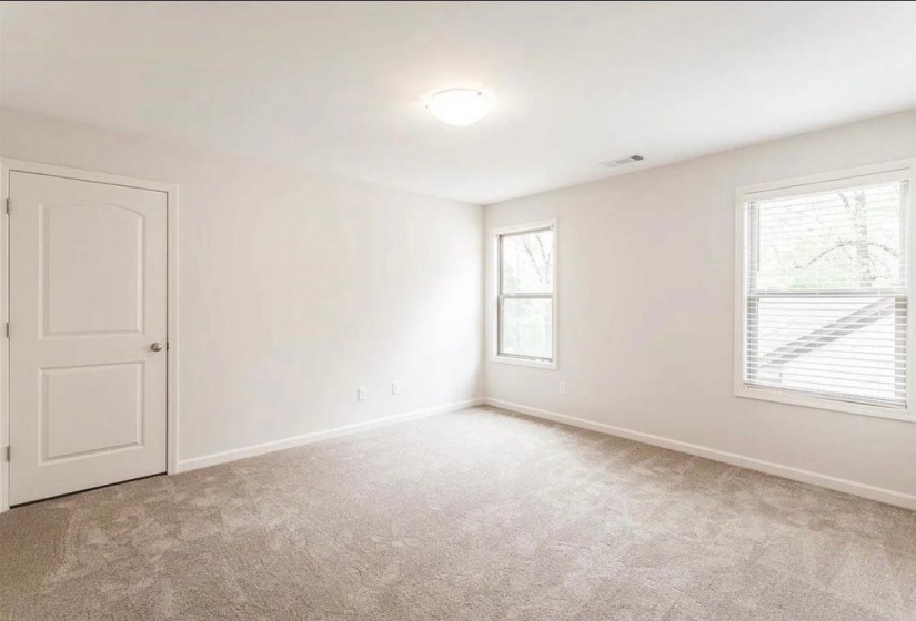 Spare room featuring light carpet and baseboards