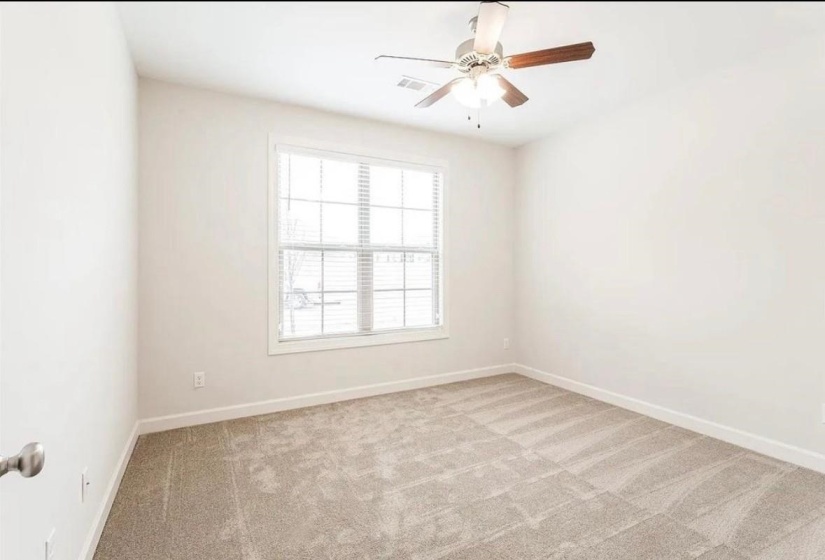 Unfurnished room featuring light colored carpet and ceiling fan