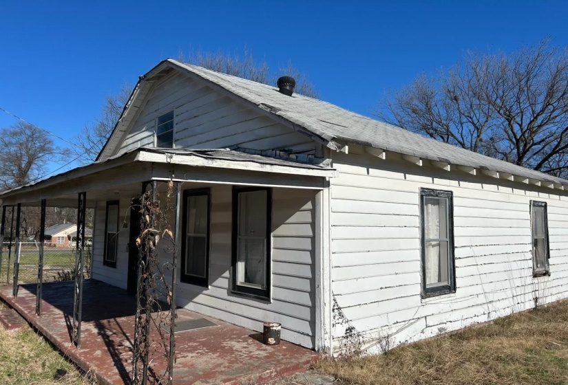 View of side of property featuring covered porch