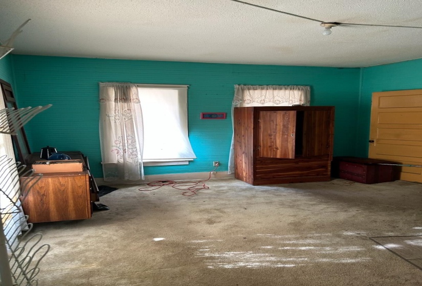 Unfurnished bedroom featuring a textured ceiling and carpet floors