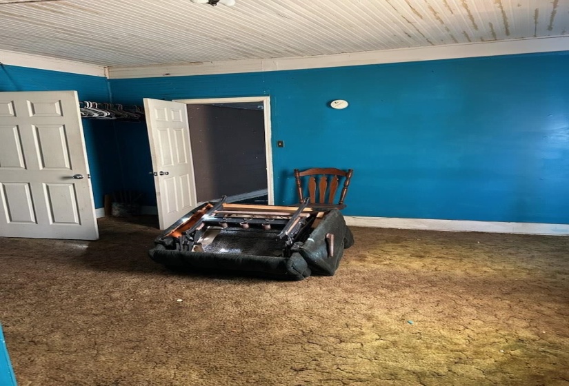 Interior space with carpet flooring and baseboards