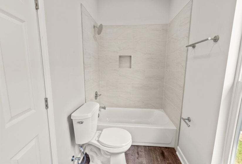 Bathroom featuring shower / tub combination and wood finished floors
