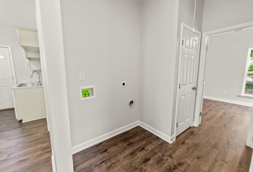 Laundry room with dark wood-style flooring, hookup for a washing machine, and hookup for an electric dryer