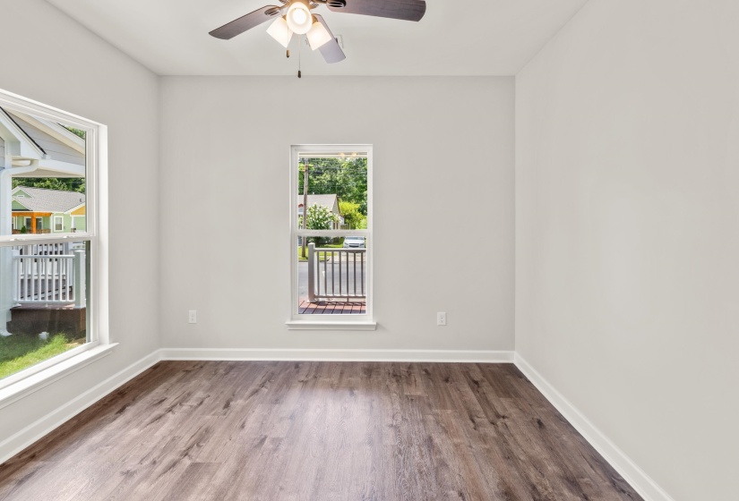 Unfurnished room featuring wood finished floors and a ceiling fan