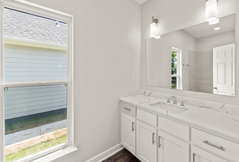 Bathroom with vanity and baseboards