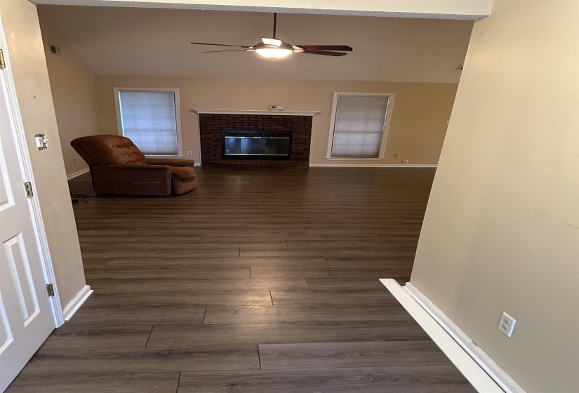 Unfurnished living room featuring a fireplace and dark wood-type flooring