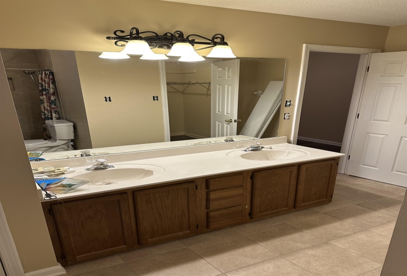 Bathroom featuring tile patterned floors, vanity, a textured ceiling, and a shower with shower curtain