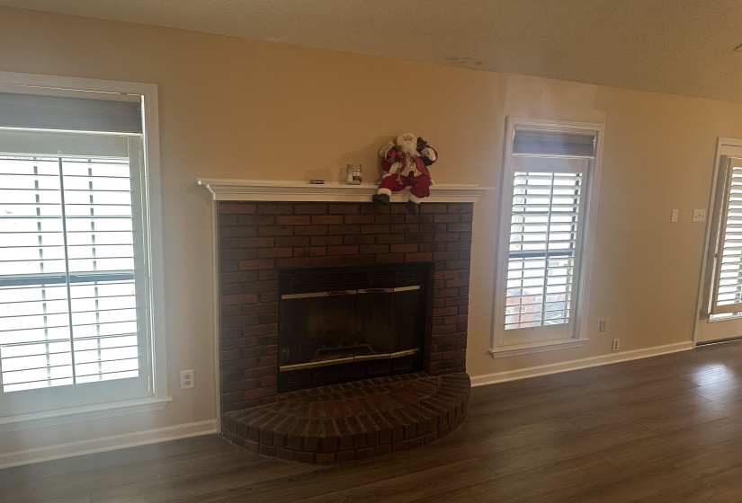 Detailed view of wood finished floors and a fireplace