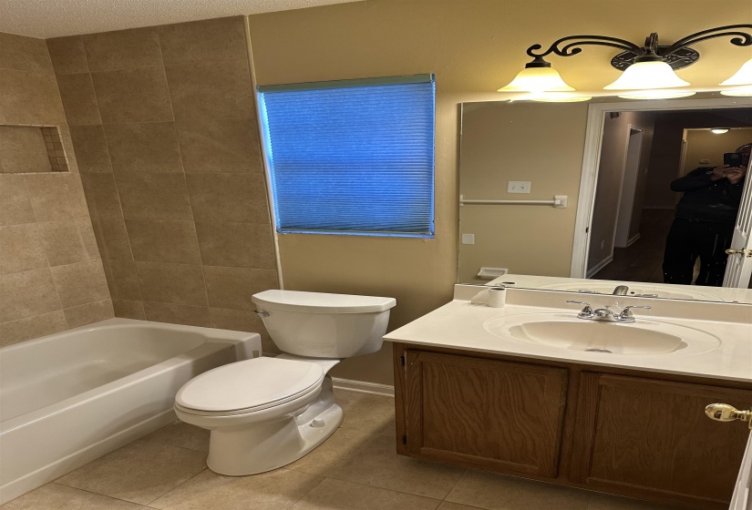 Full bathroom featuring tile patterned floors, vanity, a textured ceiling, and toilet