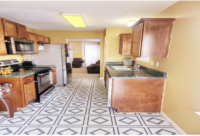 Kitchen with sink and black electric range oven