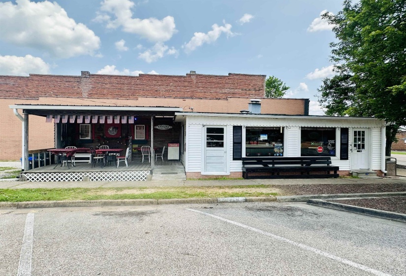View of property featuring uncovered parking