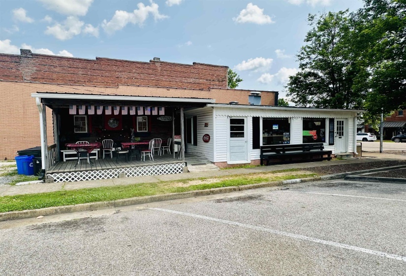 View of building exterior featuring uncovered parking