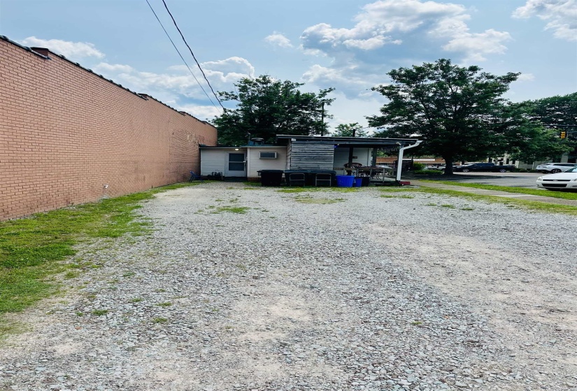 View of side of home with gravel driveway