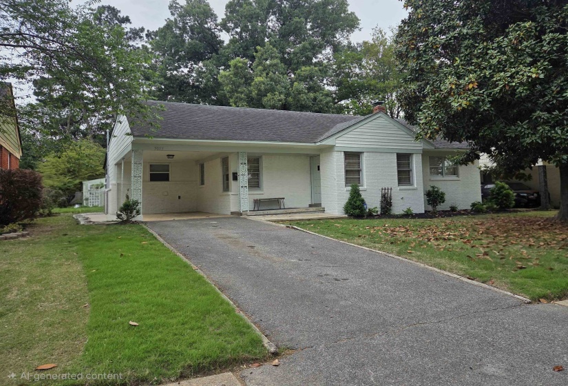 Ranch-style residence featuring white painted brick and siding, a covered carport, and a paved driveway