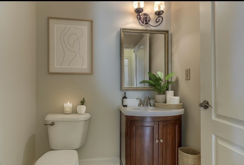 Half bathroom featuring vanity and toilet